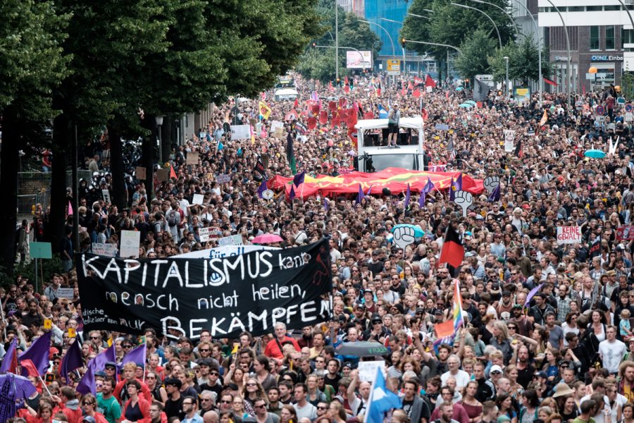 Tens of thousands of protesters rally through Hamburg